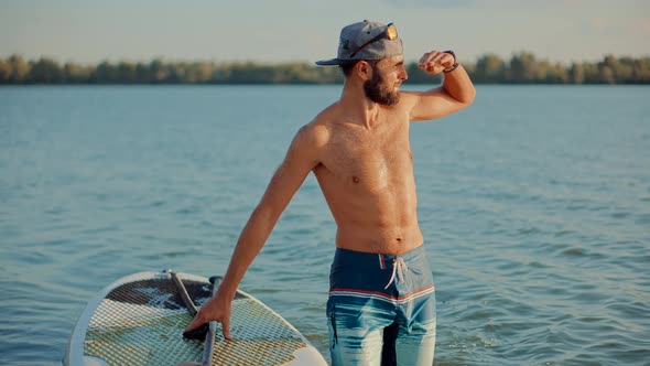 Surfer Floating Sup Board On Vacation. Tourist Floating Standup Paddle Board. Water Sport On SUP