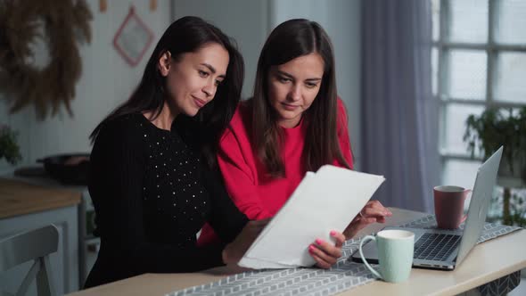 Women Freelancers Work at Home, Discuss Project, Use Documents and Laptop