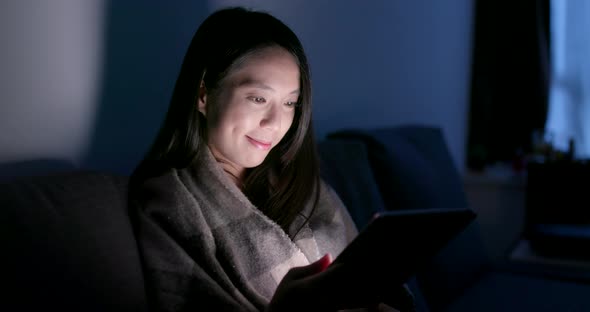 Woman use of smart phone in the evening at home