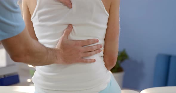 Female patient receiving back massage from physiotherapist