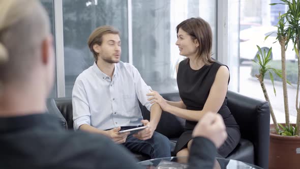 Positive Caucasian Couple Making Sale and Purchase Deal in Car Showroom or Dealership. Happy Woman