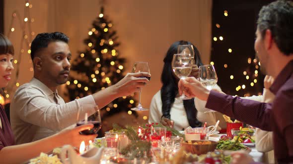 Happy Friends Having Christmas Dinner at Home