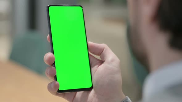 Man Using Smartphone with Green Chroma Screen