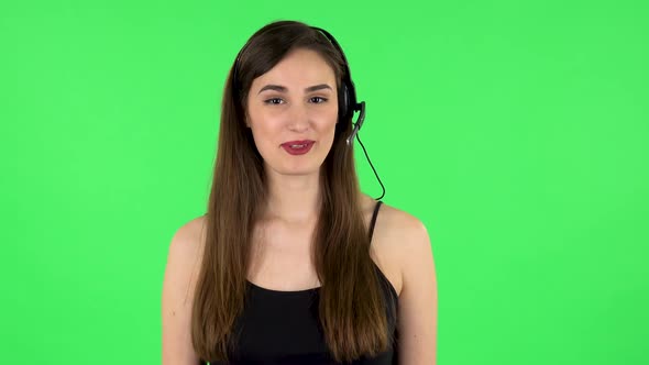 Young Girl Talking on Headphones, Call Center. Green Screen