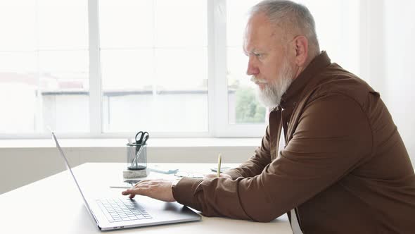 man fills out paperwork on his work desk