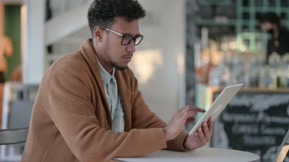 African Man Using Tablet Cafe