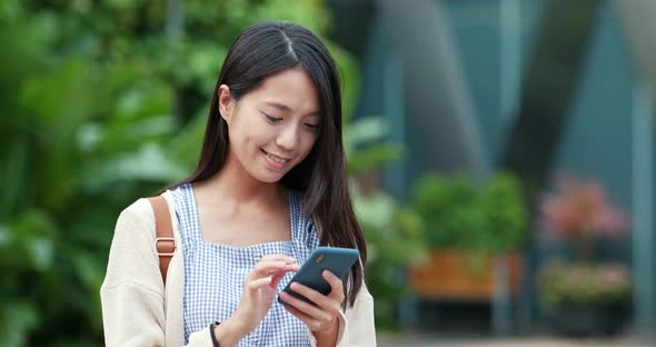 Woman use of mobile phone in city