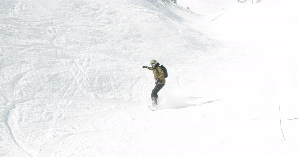 Snowboarder Jumps Down Slope