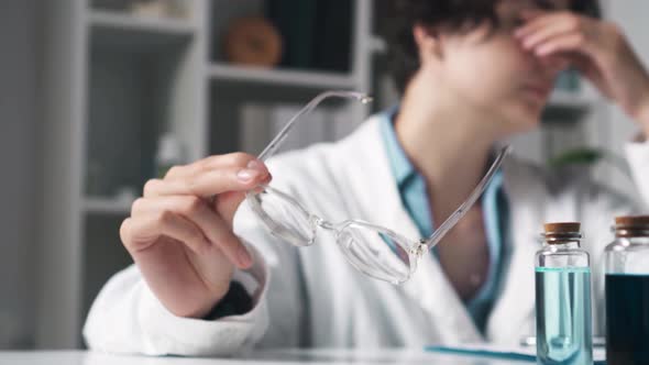 A Young Girl Doctor Nutritionist Tired At The Robot Takes Off Her Glasses To Wipe Her Eyes