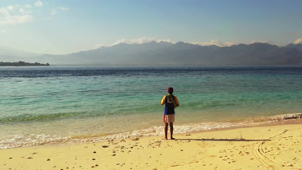 Fishing for good looking guy on a journey spends quality time on beach on summer white sand and blue