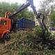 Grab Crane Loading Felled Trees into a Trucks Body 2