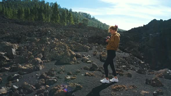 Woman Traveler Walks Through the Lava Field Around Chinyero Volcano in the Teide National Park on