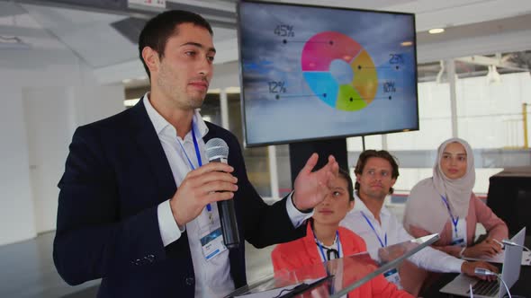 Male speaker addressing the audience at a business conference