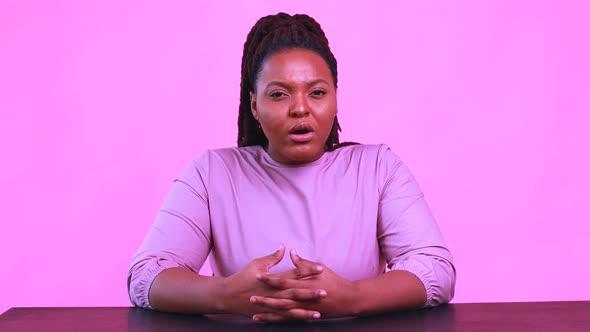 Hispanic Woman with Cool Dreadlocks Pigtails Wear Pink Dress in Studio Chatting with Her Subscribers