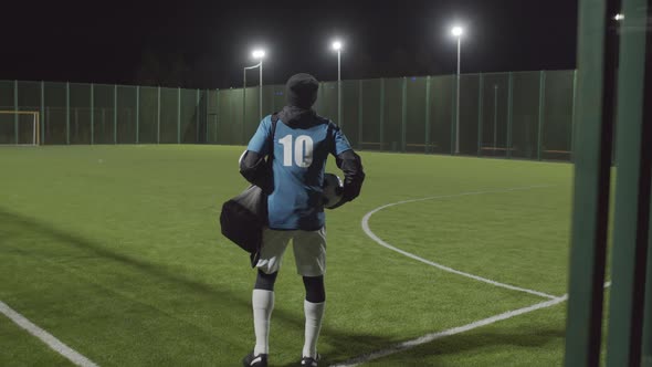 Man Leaving Soccer Field after Training