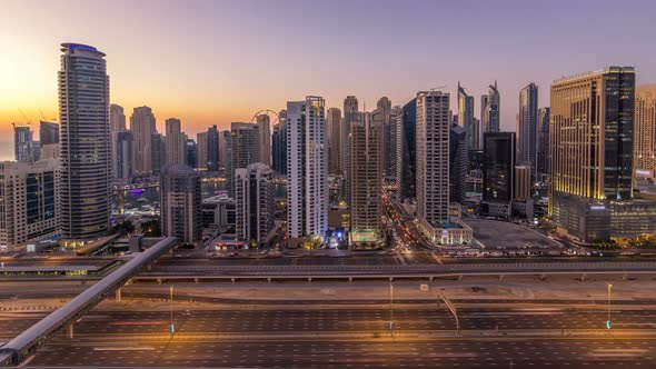 Dubai Marina with Traffic on Sheikh Zayed Road Panorama Day to Night Timelapse Lights Turn on