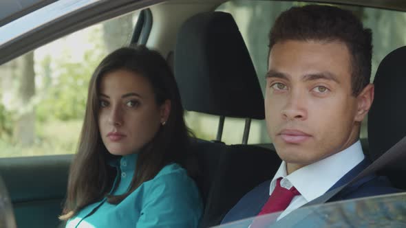 Arrogant Businesspeople Looking Out Car Window