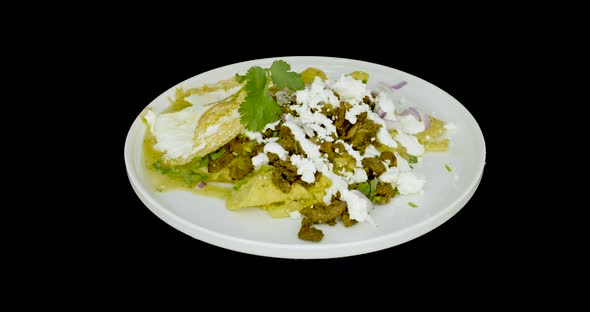 Chilaquiles with eggs on a turntable. Mexican food.