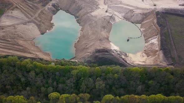 Aerial view of a sand quarry full with green water