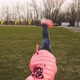Active Little Girl Doing Cartwheel on Green Grass - VideoHive Item for Sale
