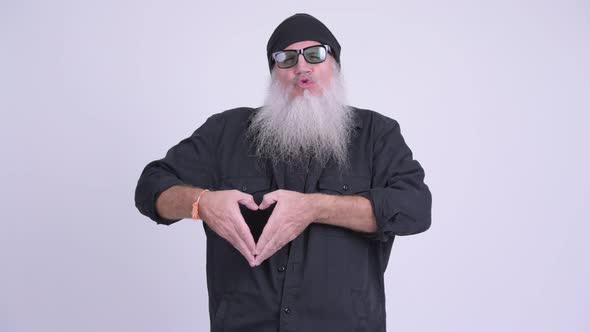 Happy Mature Bearded Hipster Man Showing Hand Heart Sign