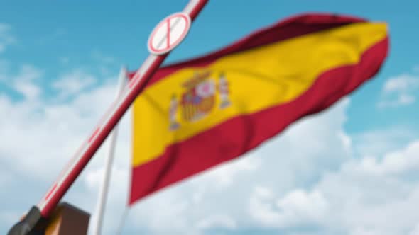 Barrier Gate with No Immigration Sign Closed at Flag of Spain alt