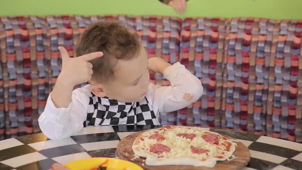 Children make pizza. Master class for children on cooking Italian pizza.