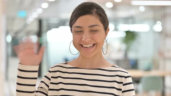 Portrait of Cheerful Indian Woman Waving at the Camera 