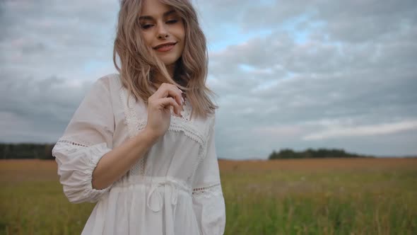 Romantic Woman in Dress Standing on Remote Rural Meadow