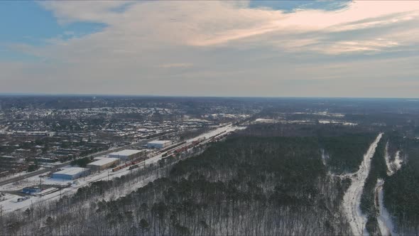 Winter Scenery of a Local Train Transporting Cargo on the Snowy Forest