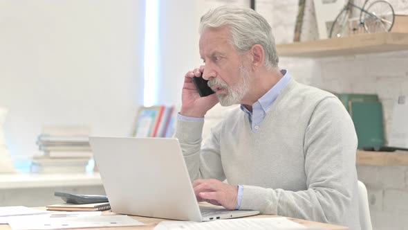 Old Man Talking on Phone, Negotiating