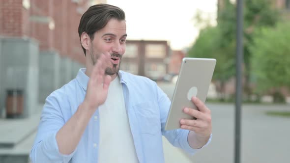 Portrait of Video Call on Tablet By Man Outdoor