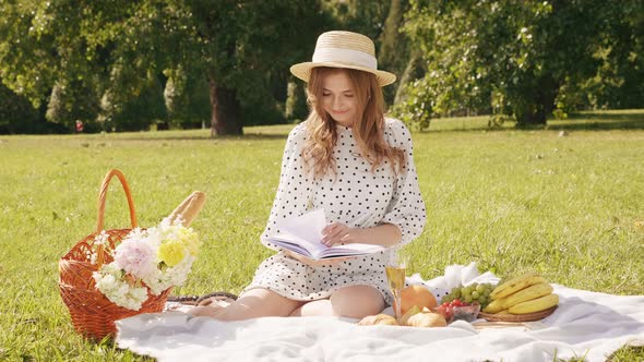 Young beautiful hipster woman in trendy summer sundress and hat posing outdoors