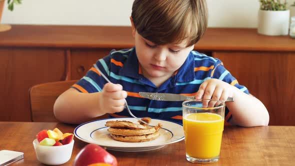 Boy having breakfast on dinning table 4k