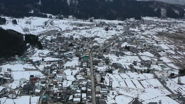 aerial of nozawa onsen village homes with little snow during winter in nagano japan