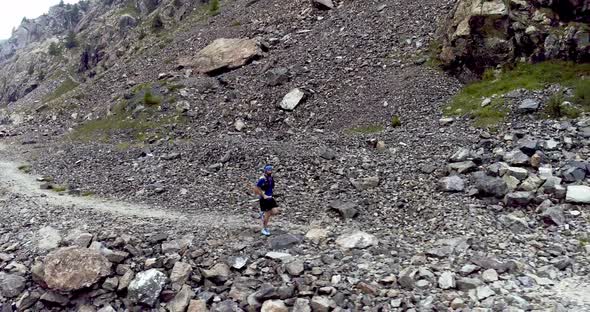 Aerial View of Young Man Running on Dirt Road in Mountain Costal