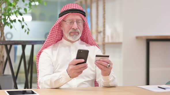 Old Arab Businessman Having Online Payment Success on Smartphone