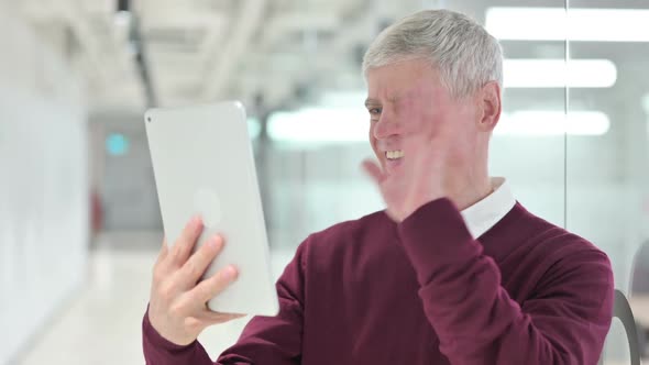 Middle Aged Man Doing Video Chat on Tablet