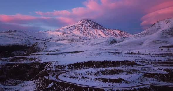 Pink Sunrise Sunset time in winter and landscape of damavand volcano in iran covered by snow in a fr