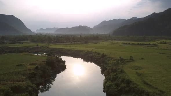 Wonderful River Reflects Yellow Sun Near Vast Peanut Fields