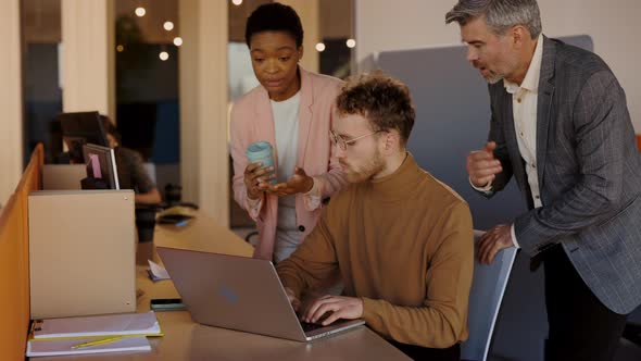 Multiethnic Business Team People Brainstorming Using Laptop Computer at Workplace