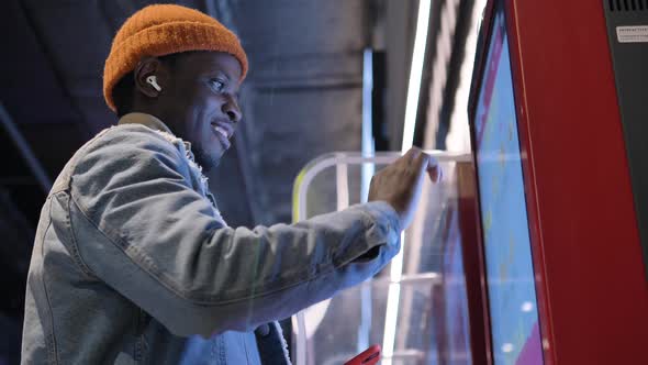 Smiling Black Man Chooses Burgers on Interactive Display