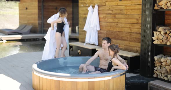 Friends Having Fun Bathing at Spa Outdoors