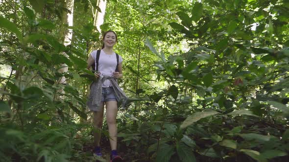 Asian Girl Walking In Deep Forest