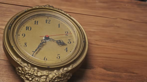 Old Retro Wall Clock with Moving Second Hand on Wooden Background