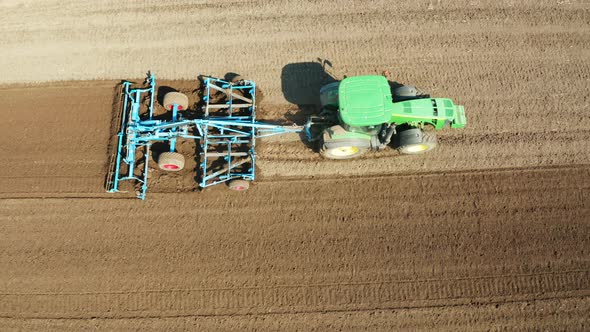 Tractor with Disc Harrows on the Farmland