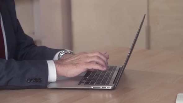 Close Up Person with Necktie Working on PC