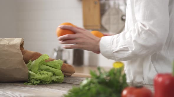 On Table Lies Natural Paper Bag Of Freshest Vegetables, Baguettes In Modern Kitchen