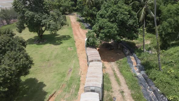 Aerial view of abandoned train wreck in forest, backwards reveal shot