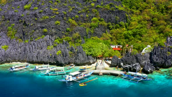 Beautiful Coral Reef, Boats and a Clear Ocean on Matinloc Island, Bacuit Archipelago